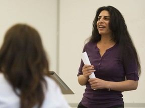 Tara Cheyenne Friedenberg (left) listens to Rawan Nassar for the Shoe Project, a public speaking presentation of immigrant women's personal stories, Vancouver  June 14 2018.