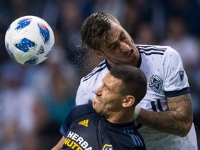 Vancouver Whitecaps' Jose Aja, back, and Los Angeles Galaxy's Daniel Steres fight for a ball during MLS action last month in Vancouver. Coach Carl Robinson says his squad needs to improve on set-piece plays and getting more aggressive in the offensive zone.