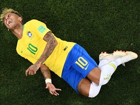 Brazilian forward Neymar reacts after being tackled against Switzerland at the World Cup on June 17.