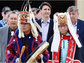 Prime Minister Justin Trudeau is led out to an event by Indigenous drummers in Prince Rupert, B.C. on Thursday, June 21, 2018.