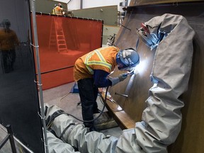 A contractor assembles turbines at the Site C construction site.