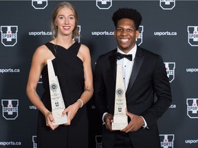 Montreal Carabins volleyball player Marie-Alex Belanger, left, of Joliette, Que., and Laurentian Voyageurs basketball player Kadre Gray, of Toronto, pose for a photograph with their trophies after being named female and male U Sports Athletes of the Year for the 2017-18 season, in Vancouver, on Monday June 4, 2018.