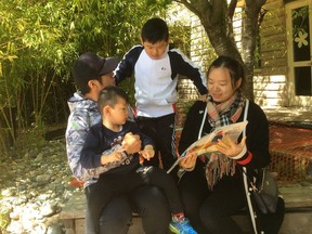 Kelvin Yang (left) and Ivy Choy, with sons Anson, 5, and Michael, 3, after one-on-one tutoring sessions through Family Literacy Outreach at Mt. Pleasant Neighbourhood House on June 9, 2018.