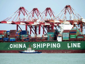 FILE - In this April 13, 2018, file photo, a China Shipping container ship is seen at the port in Qingdao in eastern China's Shandong province. China has accused the United States on Thursday, June 21, 2018, of using pressure tactics and blackmail in threatening to impose tariffs on hundreds of billions of dollars of Chinese imports. (Chinatopix via AP, File)