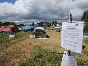 Notices to vacate Regina Park next to the Trans-Canada Highway near Uptown shopping centre were posted by the District of Saanich on Friday, June 8, 2018. Adrian Lam, Victoria Times Colonist [PNG Merlin Archive]