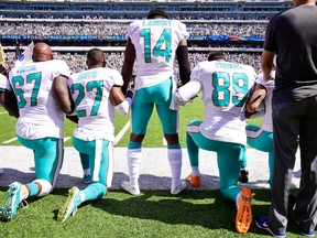 In this Sept. 24, 2017 file photo, Miami Dolphins players are shown during the playing of the national anthem before a game against the New York Jets.