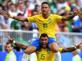 Neymar Jr of Brazil celebrates with teammate Paulinho after scoring his team's first goal during the 2018 FIFA World Cup Russia Round of 16 match between Brazil and Mexico at Samara Arena on July 2, 2018 in Samara, Russia.