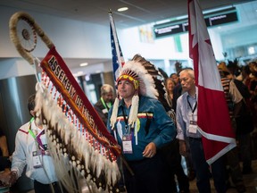 Assembly of First Nations national chief Perry Bellegarde holds the eagle staff as he waits to lead the grand entry at the opening of the AFN annual general meeting in Vancouver on Tuesday.