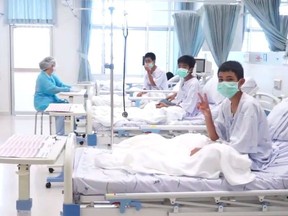 This handout video grab taken from footage released by The Thai government public relations department (PRD) and Government spokesman bureau on July 11, 2018 shows members of the "Wild Boars" football team being treated at a hospital in Chiang Rai. The 12 boys rescued from a Thai cave were passed "sleeping" on stretchers through the treacherous passageways, a former Thai Navy SEAL told AFP on July 11, giving the first clear details of an astonishing rescue mission that has captivated the world.