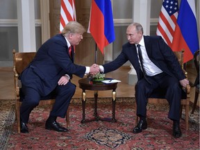 U.S. President Donald Trump shakes hands with Russia's President Vladimir Putin during a meeting in Helsinki, on July 16, 2018.
