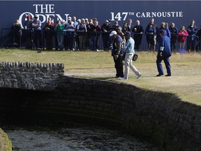 Kevin Kisner of the US talks to officials after hitting the ball into the water on the 18th hole during the second round of the British Open Golf Championship in Carnoustie, Scotland, Friday July 20, 2018.
