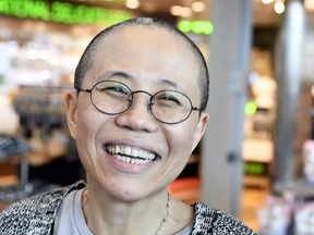 Liu Xia, the widow of Chinese Nobel dissident Liu Xiaobo, reacts as she arrives at the Helsinki International Airport in Vantaa, Finland, Tuesday, July 10, 2018.