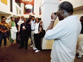 Former Black Panther Party co-founder Elbert 'Big Man' Howard (right) snaps a photo of some former colleagues at a 35th reunion in 2002.