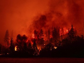 A wildfire burns in Whiskeytown, Calif. Climate change is making the world warmer because of the build-up of heat-trapping gases from the burning of fossil fuels like coal and oil and other human activities. And experts say the jet stream — which dictates weather in the Northern Hemisphere — is again behaving strangely.