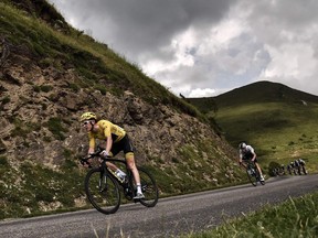 Geraint Thomas, wearing the overall leader's yellow jersey, rides downhill during the 17th stage of the 105th edition of the Tour de France, between Bagneres-de-Luchon and Saint-Lary-Soulan, on July 25, 2018.