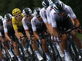 The team sky with Britain's Geraint Thomas, wearing the overall leader's yellow jersey, and Britain's Chris Froome, second left, rides during the fourteenth stage of the Tour de France cycling race over 188 kilometers (116.8 miles) with start in Saint-Paul Trois-Chateaux and Mende, France, Saturday, July 21, 2018.