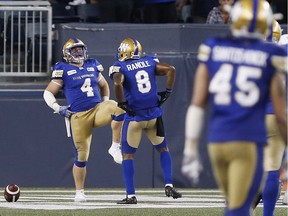 Former B.C. Lions all-star Adam Bighill dances in the end zone with his Blue Bombers teammate Chris Randle after scoring against the Lions last week in Winnipeg. Bighill will return to Vancouver on Saturday night, the first time not dressed as a B.C. Lion.