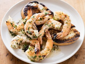 A plate of grilled shrimp with spicy lemon-garlic sauce, from the cookbook Master Of The Grill.