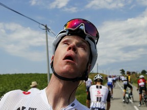 Britain's Chris Froome grimaces after being treated for tear gas or pepper spray sprayed on the peloton when a farmer's protest interrupted during the sixteenth stage of the Tour de France cycling race over 218 kilometers (135.5 miles) with start in Carcassonne and finish in Bagneres-de-Luchon, France, , Tuesday, July 24, 2018.