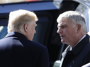 U.S. President Donald Trump (left) speaks with Pastor Franklin Graham at a funeral service in Charlotte, N.C., in March 2018.