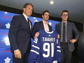 Prized free agent signing John Tavares, flanked by Maple Leafs president Brendan Shanahan (left) and general manager Kyle Dubas (right), announcing the US $77-million, seven-year deal on Sunday.