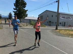 Amalie Mayo waves to spectators as she heads for the finish line in Sunday's MEC Langley 10K Runway race at Abbotsford International Airport. Mayo was 11th in the women's division. More than 200 people participated in the annual 10K and 5K road races at YXX.
