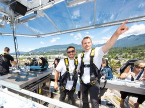 Dinner in the Sky Canada executive chef Evan Elman (left) and Dinner in the Sky Canada ambassador Ned Bell take in the views before serving dinner to guests at 130 feet up.