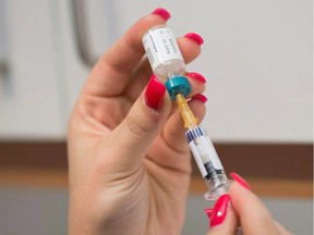 A doctor's assistant prepares a measles vaccination. The B.C. government is considering ways to boost access to the vaccine, as well as mandatory registration of immunization for school children.