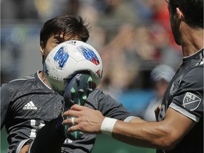 Vancouver Whitecaps forward Nicolas Mezquida makes a high kick on the ball during the second half of an MLS soccer match against the Seattle Sounders, Saturday, July 21, 2018, in Seattle.