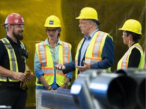 B.C. Premier John Horgan (centre) Minister of Advanced Education Melanie Mark (right) and Minister of Transport Claire Trevena during a tour of the ironworkers training facility at BCIT in Burnaby, BC, July, 16, 2018.