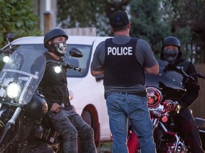 Police stop members of the Los Diablos, a puppet club of the Hell Angels, in Nanaimo, BC, July, 21, 2018.