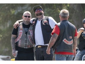 Members Hells Angels pose for a picture while gathering out front of the Nanaimo Hell Angels' clubhouse in Nanaimo, BC, July, 21, 2018.