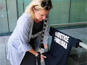 Clara Gordic, mother of slain Burnaby teen Luka Gordic, displays a Justice for Luke T-shirt outside B.C. Supreme Court sentencing hearing in Vancouver Monday.
