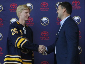 Swedish defenceman Rasmus Dahlin, the first overall pick in the 2018 NHL Entry Draft, greets Buffalo Sabres general manager Jason Botterill on June 25 in Buffalo, N.Y.