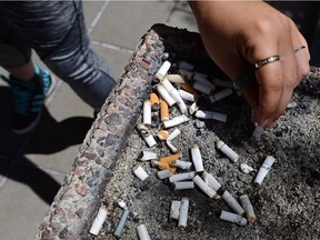 The Supreme Court of Canada says British Columbia does not have to give a tobacco company access to detailed provincial health databases to ensure the fairness of a multibillion-dollar damages trial. A smoker puts out a cigarette in a public ash tray in Ottawa on Tuesday, May 31, 2016.