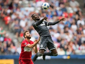 Vancouver Whitecaps' Kei Kamara, right, jumps above Chicago Fire's Jonathan Campbell during MLS action in Vancouver, on Saturday July 7, 2018.