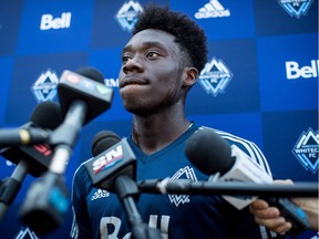 Alphonso Davies of the Vancouver Whitecaps listens to questions during a news conference at the MLS team's training facility in Vancouver, on Thursday. The Whitecaps confirmed that German soccer giant Bayern Munich agreed to a transfer deal for the 17-year-old Canadian, in a move that according to the team could amount to more than US $22 million, the most ever received by an MLS club. Bayern said Davies' contract runs until 2023.