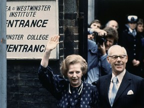 n this June 9, 1983 file photo, British Prime Minister Margaret Thatcher leaves the Castle lane, Westminster, England polling station with her husband, Dennis, after casting their votes in the general election.