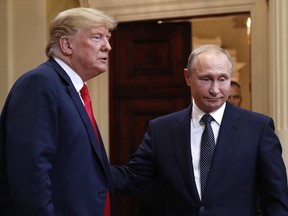 U.S. President Donald Trump, left, and Russian President Vladimir Putin leave a press conference after their meeting at the Presidential Palace in Helsinki, Finland, Monday, July 16, 2018.