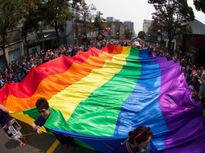 A giant rainbow flag is carried on Robson Street during the Vancouver Pride Parade last summer.