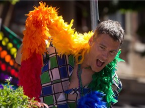Vancouver Mayor Gregor Robertson dances while wearing a rainbow boa during the Vancouver Pride Parade in Vancouver, B.C., on Sunday August 3, 2014.