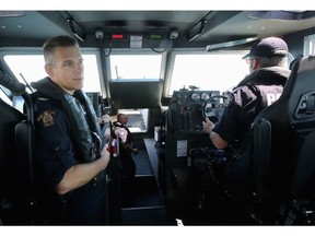 RCMP Sgt. Michael Fox (left) patrols the waters between Canada and the U.S. as part of the Shiprider program.