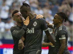 Russell Teibert of the Vancouver Whitecaps, left, congratulates teammate Kei Kamara after he scored a second-half goal in Vancouver's 2-0 victory against the visiting Montreal Impact on Wednesday.