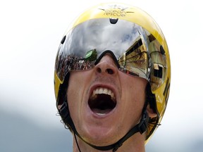 Britain's Geraint Thomas, wearing the overall leader's yellow jersey reacts as he crosses the finish line during the twentieth stage of the Tour de France cycling race, an individual time trial over 31 kilometers (19.3 miles) with start in Saint-Pee-sur-Nivelle and finish in Espelette, France, Saturday, July 28, 2018.