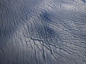 Crevasses in a glacier are seen from NASA's Operation IceBridge research aircraft along the Upper Baffin Bay coast on March 27, 2017 above Greenland.