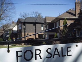 A for sale sign is shown in front of west-end Toronto homes Sunday, April 9, 2017.