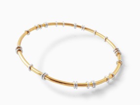 Satellite Bangle in gold and silver from the brand IZA Jewelry.
