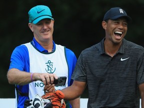 The smile and TV ratings are both back as Tiger Woods shares a joke with his caddie Joe LaCava during the Pro-Am event held before the start of The Northern Trust at Ridgewood CC, on Aug. 22 in Ridgewood, N.J.