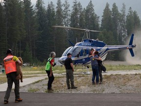 A 52-year-old woman and her dog are both safe and unharmed after wandering lost for 72 hours in the thick woods in southeastern B.C. RCMP Sgt. Chris Newel says Louise Baxter hopped off a rescue helicopter Wednesday, hugged her husband and was talking and laughing with her rescuers.