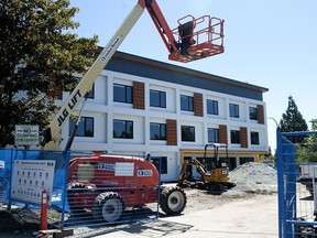 A unit of prefabricated stacked housing units goes up in Vancouver.